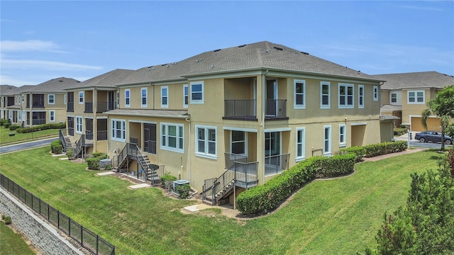 17458 Chateau Pine Way, Clermont, FL 34711 - rear view of house with stucco siding, a balcony, stairway, and a residential view
