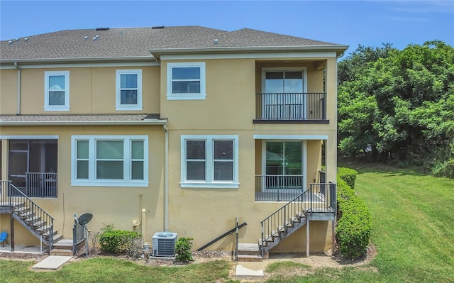 17458 Chateau Pine Way, Clermont, FL 34711 - back of property with stairs, stucco siding, and a lawn