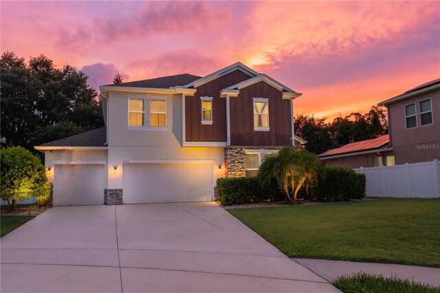 4024 Blazewater Ct, Eustis, FL 32736 - view of front of house with stone siding, a garage, concrete driveway, and board and batten siding