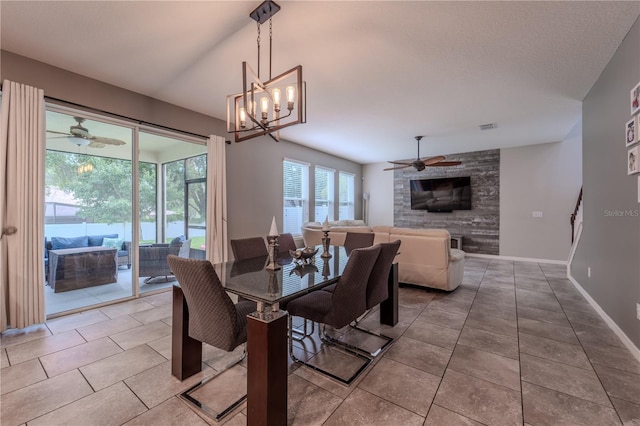 4024 Blazewater Ct, Eustis, FL 32736 - dining area featuring ceiling fan, a large fireplace, light tile patterned floors, and a chandelier