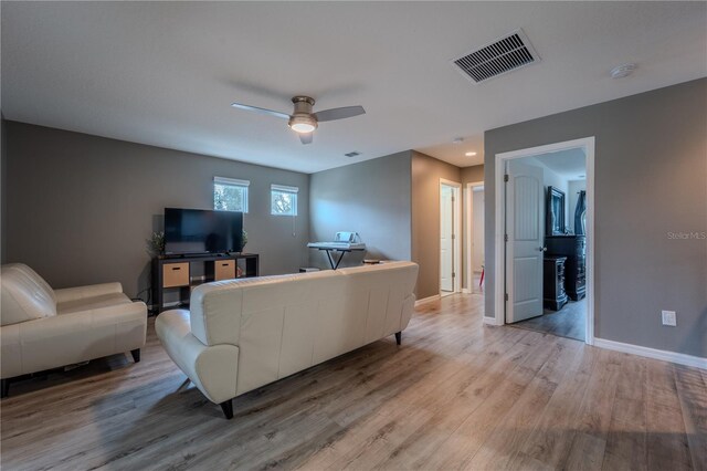 4024 Blazewater Ct, Eustis, FL 32736 - living area featuring light wood finished floors and a ceiling fan