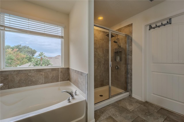 4024 Blazewater Ct, Eustis, FL 32736 - full bathroom featuring a bath, a shower stall, and stone finish flooring