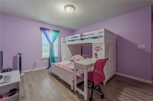 4024 Blazewater Ct, Eustis, FL 32736 - bedroom featuring wood finished floors and a textured ceiling
