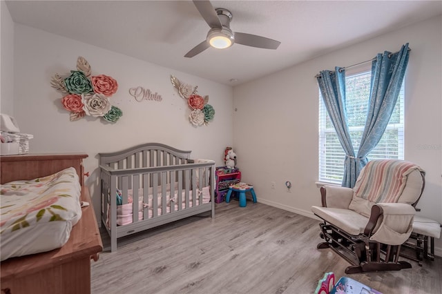 4024 Blazewater Ct, Eustis, FL 32736 - bedroom featuring multiple windows, wood finished floors, a ceiling fan, and a nursery area
