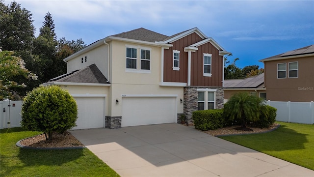 4024 Blazewater Ct, Eustis, FL 32736 - traditional-style home with stone siding, an attached garage, board and batten siding, and concrete driveway