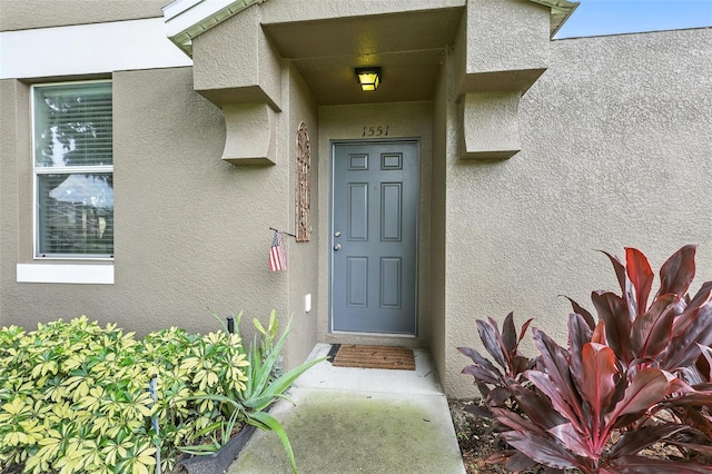 1551 Scarlet Oak Loop Unit B, Winter Garden, FL 34787 - doorway to property featuring stucco siding