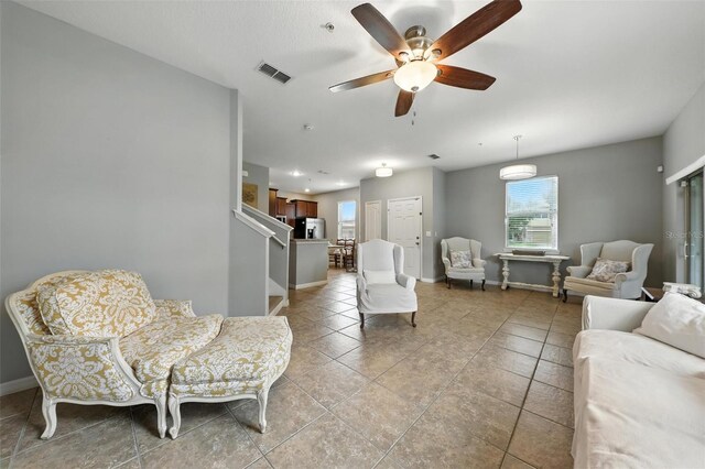 1551 Scarlet Oak Loop Unit B, Winter Garden, FL 34787 - living area featuring light tile patterned floors, a ceiling fan, and stairway