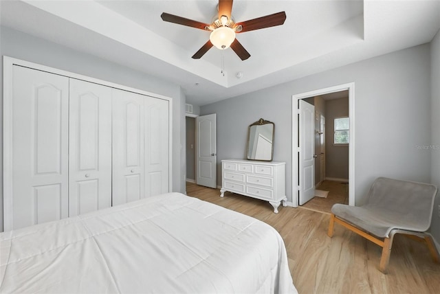 1551 Scarlet Oak Loop Unit B, Winter Garden, FL 34787 - bedroom with a tray ceiling, wood finished floors, a closet, and ceiling fan