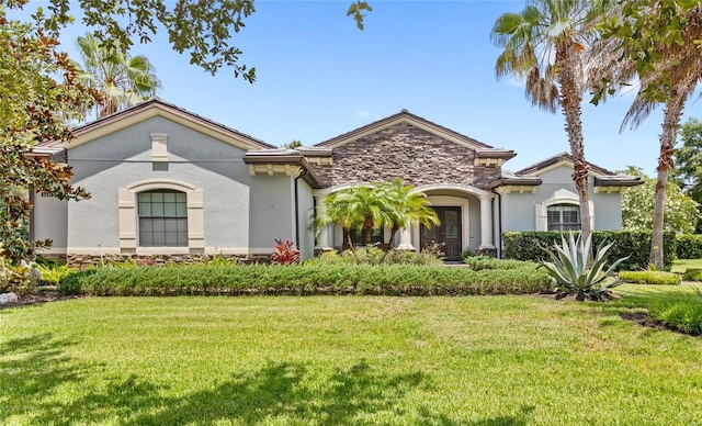 32619 View Haven Ln, Sorrento, FL 32776 - view of front facade with stucco siding, a front lawn, and stone siding