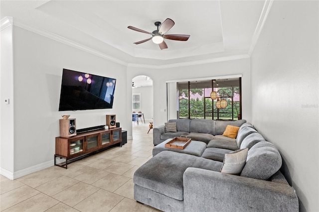 32619 View Haven Ln, Sorrento, FL 32776 - living room with a tray ceiling, arched walkways, a ceiling fan, light tile patterned floors, and crown molding