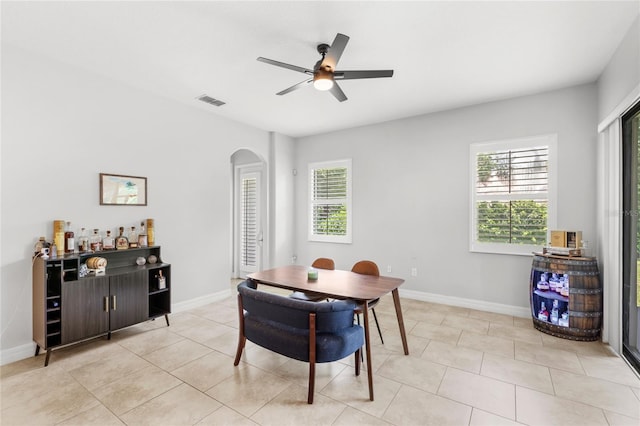 32619 View Haven Ln, Sorrento, FL 32776 - dining area featuring arched walkways, ceiling fan, and light tile patterned floors
