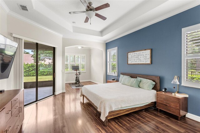 32619 View Haven Ln, Sorrento, FL 32776 - bedroom featuring access to outside, multiple windows, wood finished floors, a raised ceiling, and crown molding