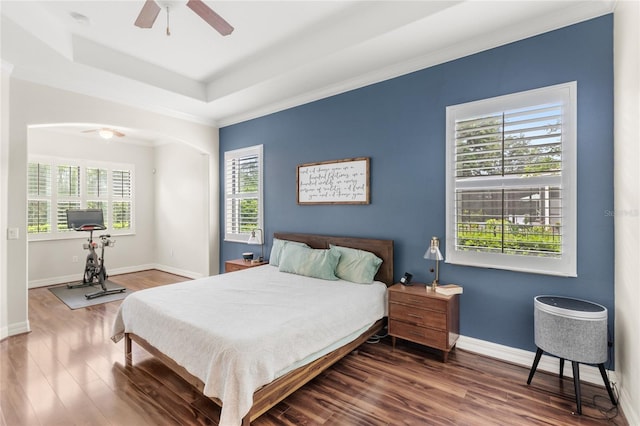 32619 View Haven Ln, Sorrento, FL 32776 - bedroom featuring wood finished floors, ornamental molding, arched walkways, a ceiling fan, and a raised ceiling