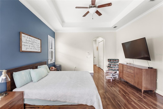 32619 View Haven Ln, Sorrento, FL 32776 - bedroom featuring a raised ceiling, arched walkways, dark wood-style floors, ornamental molding, and a ceiling fan