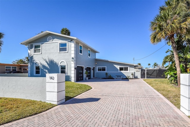 142 Reef Rd, South Daytona, FL 32119 - view of front of home with a garage, decorative driveway, and stucco siding