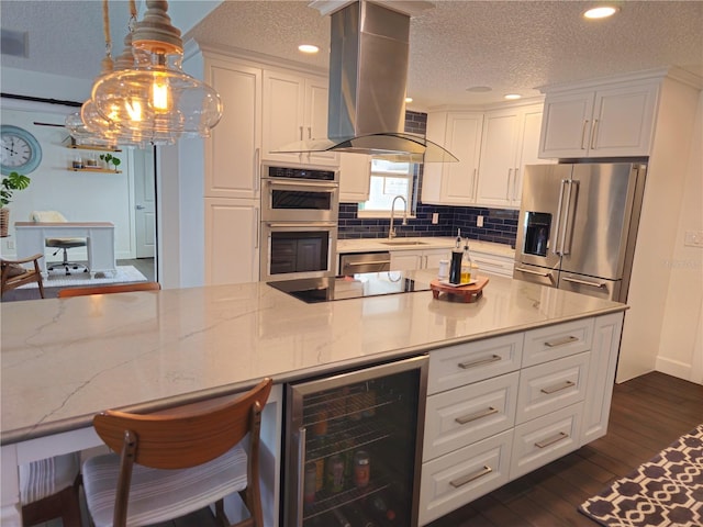 142 Reef Rd, South Daytona, FL 32119 - kitchen featuring beverage cooler, stainless steel appliances, a textured ceiling, white cabinets, and recessed lighting