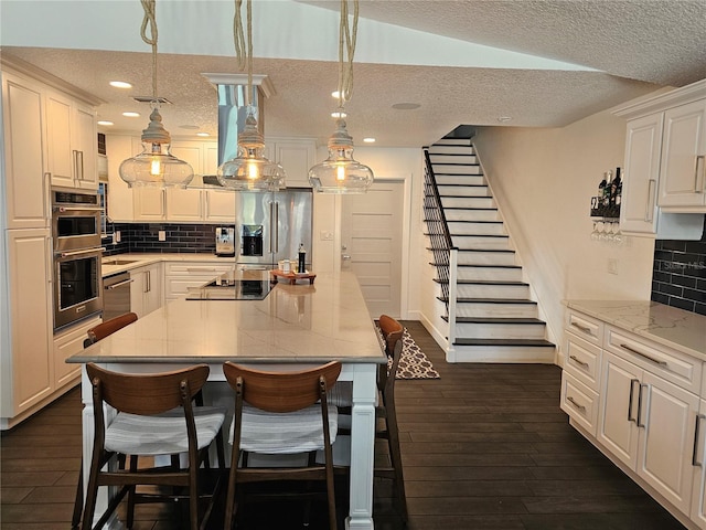 142 Reef Rd, South Daytona, FL 32119 - kitchen featuring appliances with stainless steel finishes, a textured ceiling, dark wood-style flooring, recessed lighting, and white cabinets