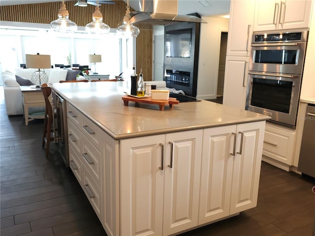 142 Reef Rd, South Daytona, FL 32119 - kitchen featuring appliances with stainless steel finishes, dark wood-style floors, beverage cooler, and open floor plan