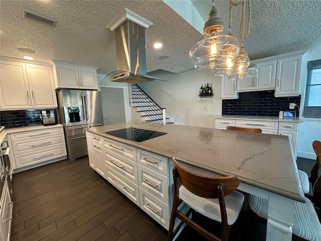 142 Reef Rd, South Daytona, FL 32119 - kitchen with high end refrigerator, black electric cooktop, white cabinets, backsplash, and a textured ceiling