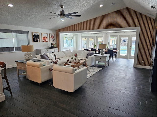 142 Reef Rd, South Daytona, FL 32119 - living area featuring lofted ceiling, ceiling fan, dark wood-style flooring, a textured ceiling, and french doors