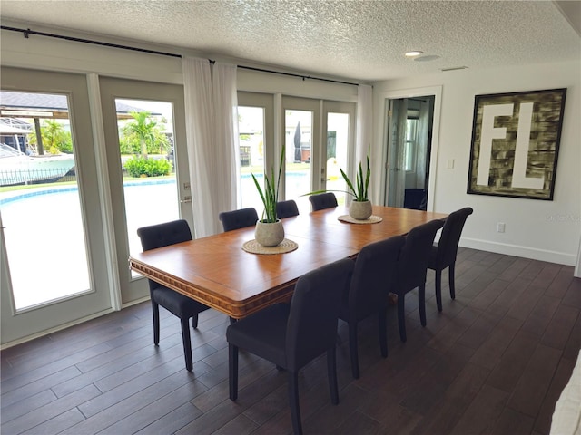 142 Reef Rd, South Daytona, FL 32119 - dining space with a textured ceiling and dark wood finished floors