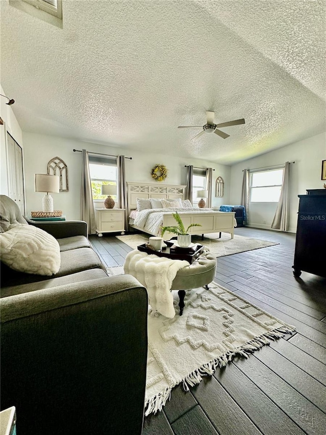 142 Reef Rd, South Daytona, FL 32119 - bedroom featuring multiple windows, hardwood / wood-style floors, a textured ceiling, and ceiling fan