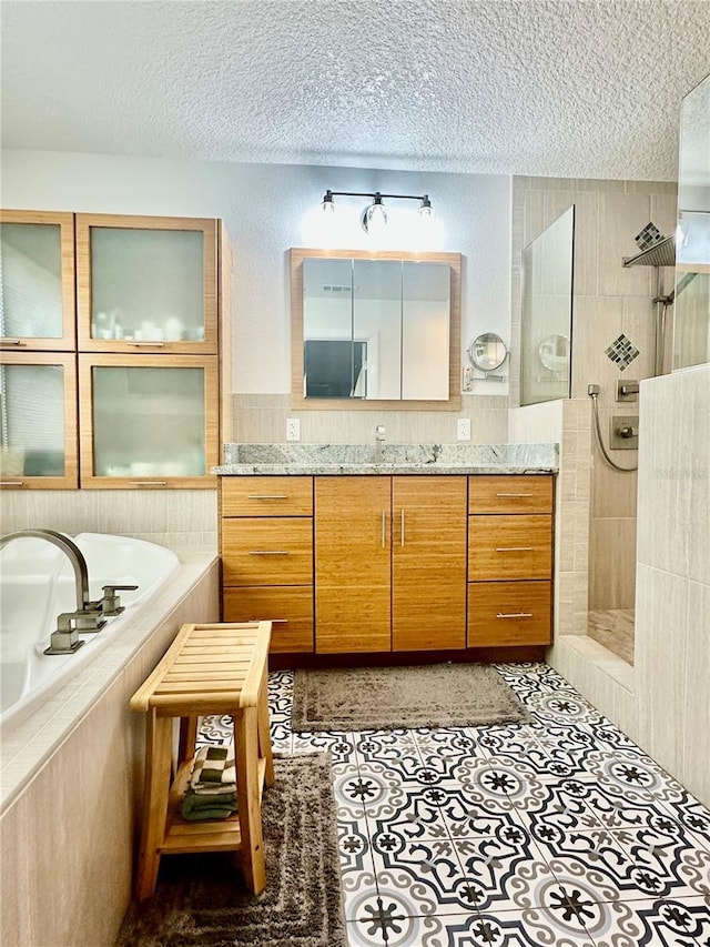 142 Reef Rd, South Daytona, FL 32119 - bathroom with a textured ceiling, vanity, walk in shower, and a garden tub