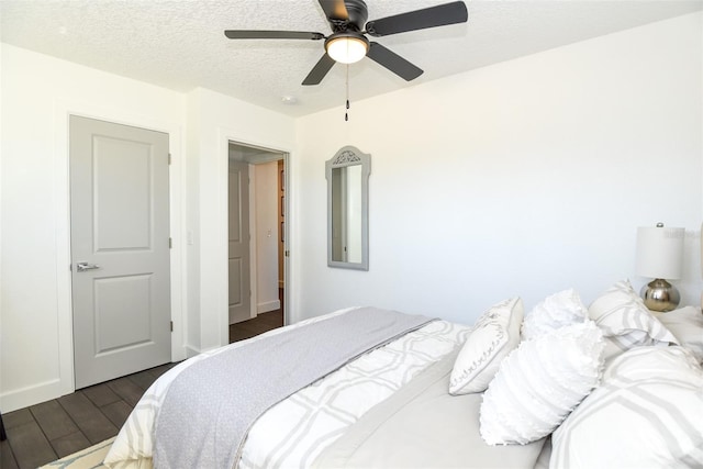 142 Reef Rd, South Daytona, FL 32119 - bedroom featuring dark wood-style flooring, ceiling fan, and a textured ceiling