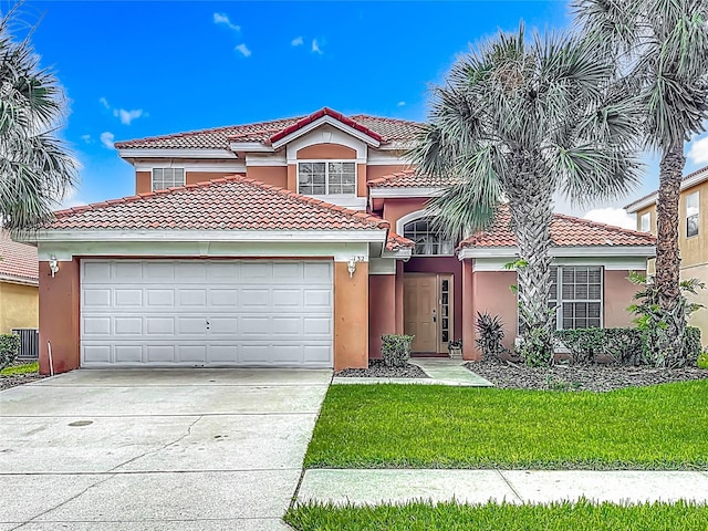 132 Cordova Ave, Davenport, FL 33897 - mediterranean / spanish house featuring a tile roof, driveway, a garage, and stucco siding