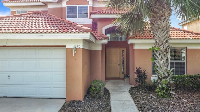 132 Cordova Ave, Davenport, FL 33897 - doorway to property featuring a tile roof, stucco siding, and an attached garage