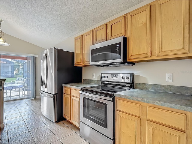 132 Cordova Ave, Davenport, FL 33897 - kitchen featuring appliances with stainless steel finishes, vaulted ceiling, a textured ceiling, light tile patterned floors, and light brown cabinetry