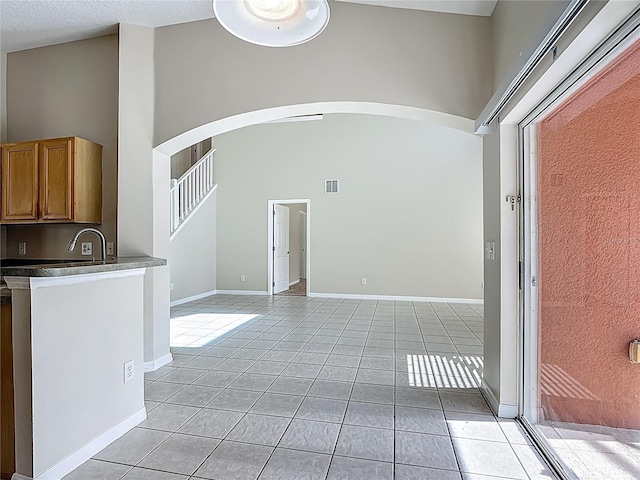 132 Cordova Ave, Davenport, FL 33897 - unfurnished room featuring arched walkways and light tile patterned floors