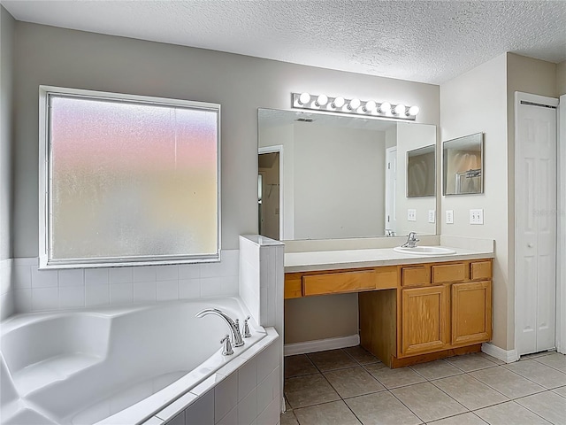 132 Cordova Ave, Davenport, FL 33897 - bathroom with vanity, a bath, tile patterned floors, and a textured ceiling