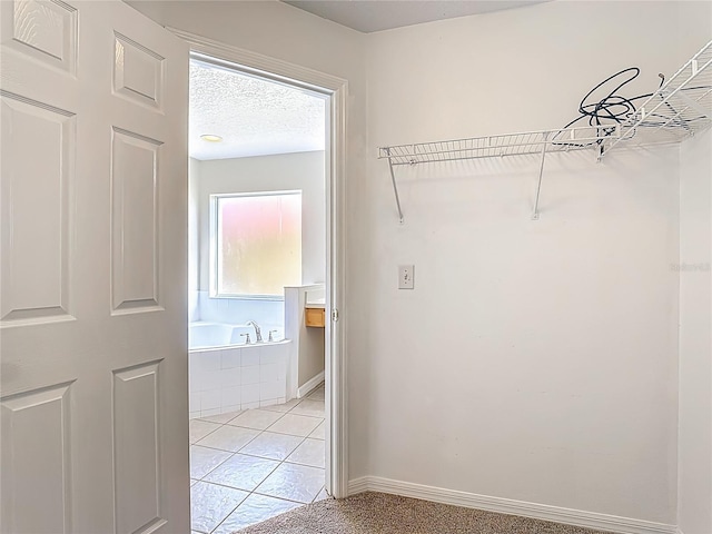 132 Cordova Ave, Davenport, FL 33897 - walk in closet with light tile patterned floors