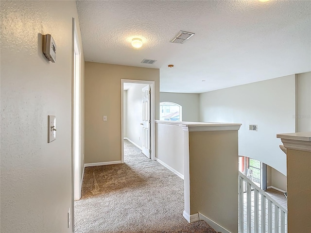 132 Cordova Ave, Davenport, FL 33897 - hall featuring an upstairs landing, a textured ceiling, and carpet