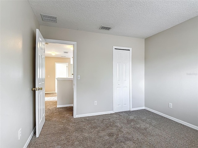 132 Cordova Ave, Davenport, FL 33897 - unfurnished bedroom featuring carpet floors, a closet, and a textured ceiling