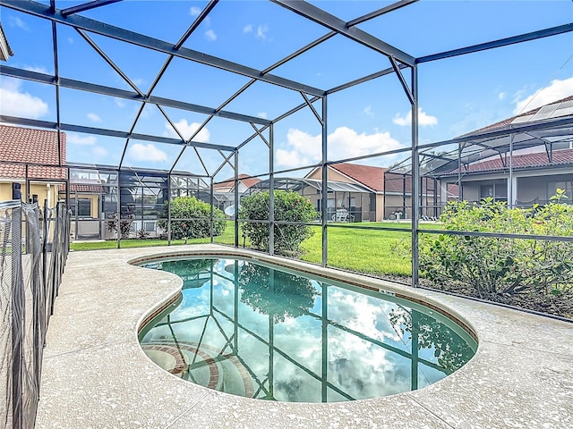 132 Cordova Ave, Davenport, FL 33897 - outdoor pool featuring a lawn, a residential view, a patio area, and glass enclosure