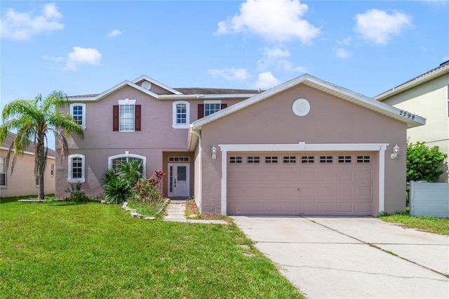 2298 The Oaks Blvd, Kissimmee, FL 34746 - view of front of home featuring stucco siding, a front yard, driveway, and a garage