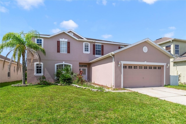 2298 The Oaks Blvd, Kissimmee, FL 34746 - view of front of house with stucco siding, concrete driveway, a front lawn, and an attached garage