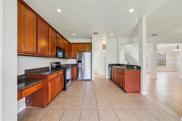 2298 The Oaks Blvd, Kissimmee, FL 34746 - kitchen with stainless steel appliances, light tile patterned flooring, dark stone counters, recessed lighting, and crown molding
