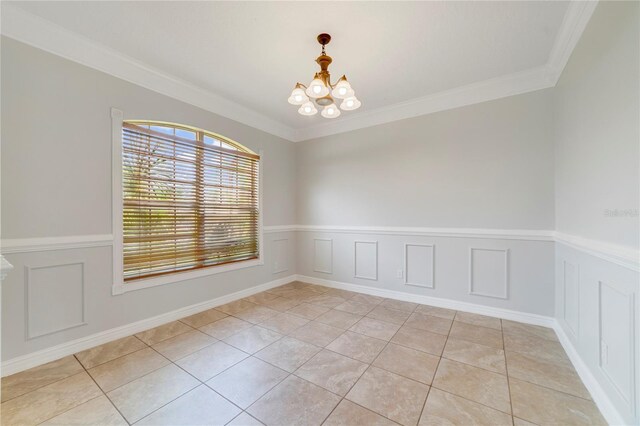 2298 The Oaks Blvd, Kissimmee, FL 34746 - spare room featuring a chandelier, light tile patterned flooring, ornamental molding, a wainscoted wall, and a decorative wall