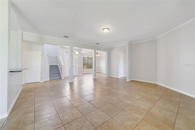 2298 The Oaks Blvd, Kissimmee, FL 34746 - empty room featuring stairs, light tile patterned floors, and ornamental molding