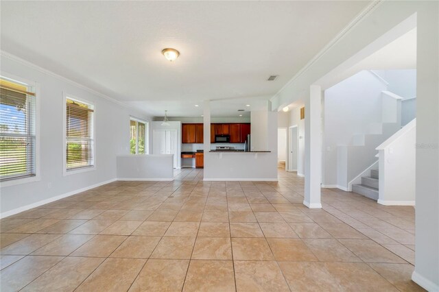 2298 The Oaks Blvd, Kissimmee, FL 34746 - unfurnished living room with ornamental molding, light tile patterned floors, and stairs