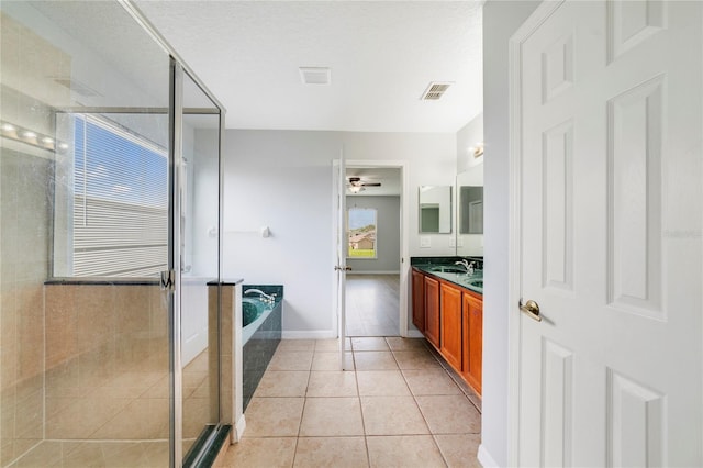 2298 The Oaks Blvd, Kissimmee, FL 34746 - full bath with vanity, a garden tub, a shower stall, a ceiling fan, and tile patterned flooring