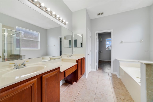 2298 The Oaks Blvd, Kissimmee, FL 34746 - full bath with vanity, a stall shower, a bath, and tile patterned flooring