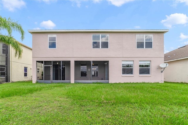 2298 The Oaks Blvd, Kissimmee, FL 34746 - rear view of property featuring stucco siding and a lawn