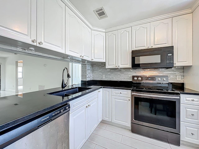 6140 Burnside Cir Unit 204, Orlando, FL 32822 - kitchen with appliances with stainless steel finishes, dark countertops, white cabinets, and backsplash