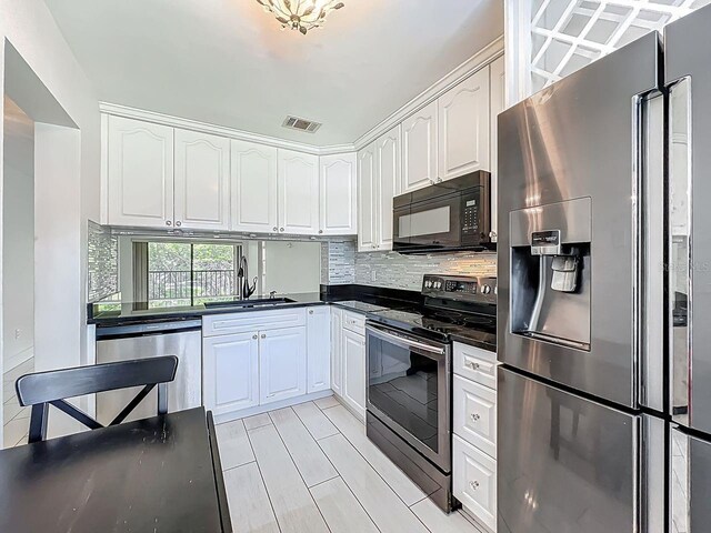 6140 Burnside Cir Unit 204, Orlando, FL 32822 - kitchen featuring stainless steel appliances, dark countertops, white cabinets, and backsplash