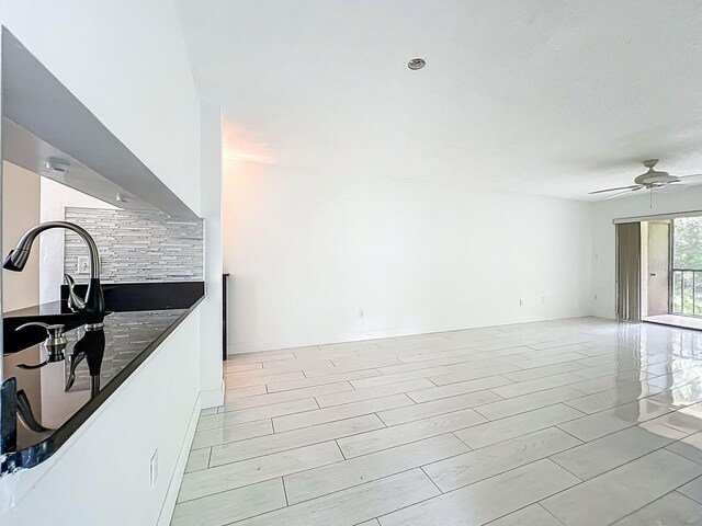 6140 Burnside Cir Unit 204, Orlando, FL 32822 - kitchen featuring dark countertops, ceiling fan, and open floor plan