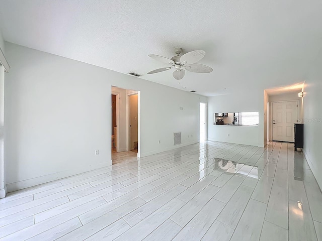 6140 Burnside Cir Unit 204, Orlando, FL 32822 - unfurnished room with a ceiling fan, light wood-style floors, and a textured ceiling